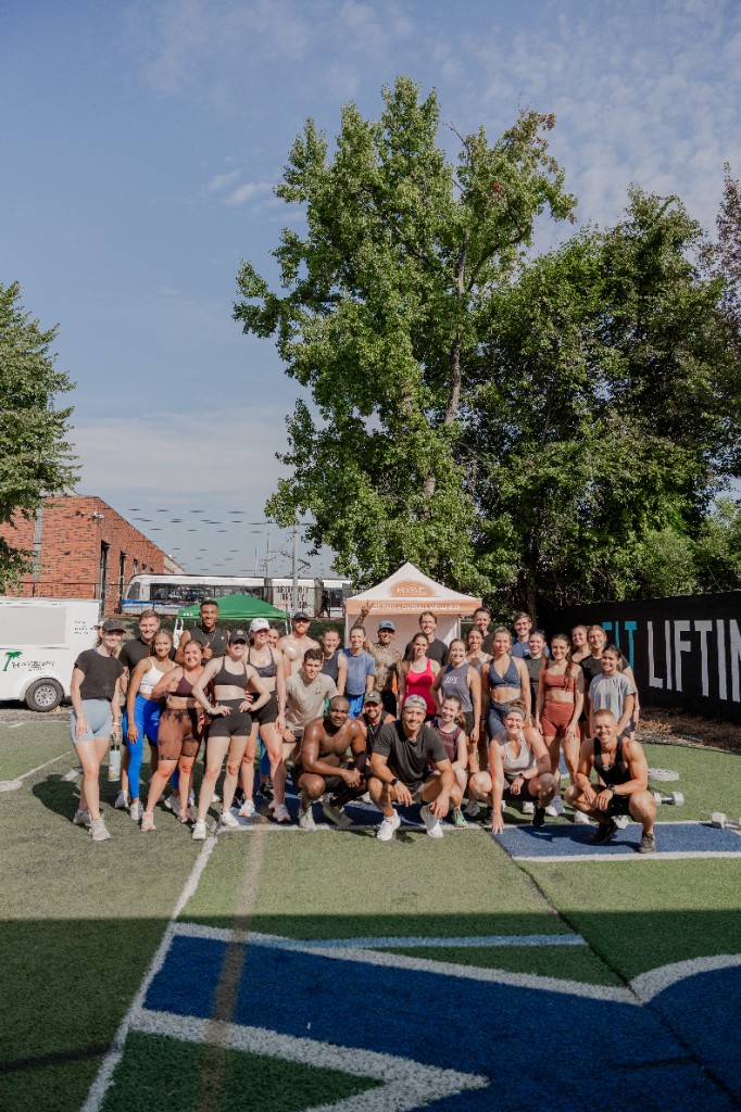 Members of CLT Lifting Club gathered on the outdoor turf field in Charlotte